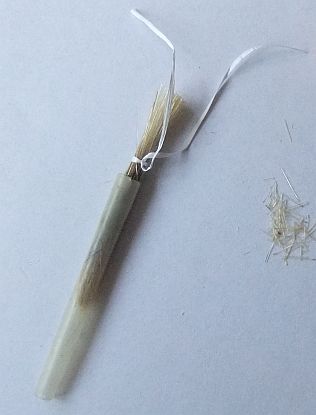 haarbundel in de schacht/ spoel geschoven